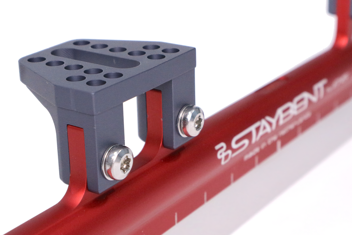 StayBent QCS 短道速滑冰刀，红色刀管上的刀托和 StayBent 字标特写